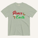 a muted sage green t-shirt with the text "Peace on Earth" and small botanical graphics