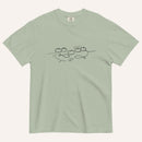 A sage green short-sleeve crewneck t-shirt with a black graphic of two fish and 5 loaves of bread on a line and the cursive text 'Everyone Ate' across the chest, displayed flat against a light beige background.