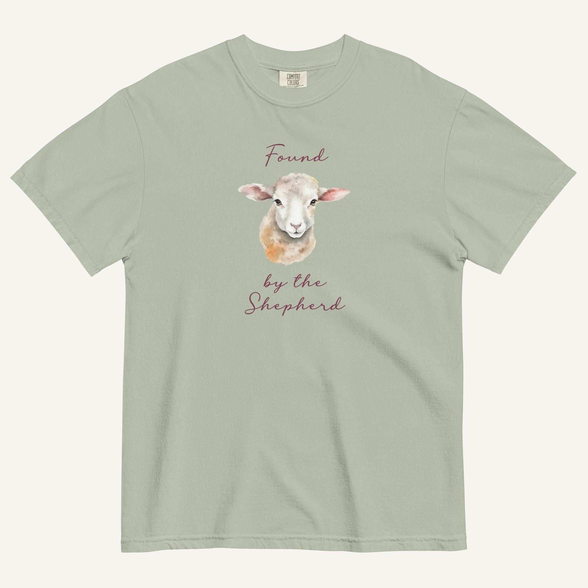 sage green t-shirt with watercolor lamb and 'Found by the Shepherd' text on cream background