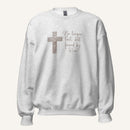 Ash grey sweatshirt with cross design and 'No longer lost, but found by Him' text on a cream background