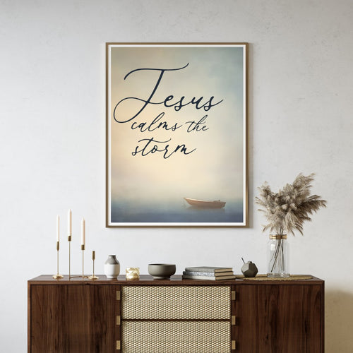 'Jesus calms the storm' text wall art with a small boat art background hanging on a neutral living room wall