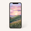 Smartphone displaying a scenic wallpaper of a sunset over rolling hills and a field with flowers on a white background.