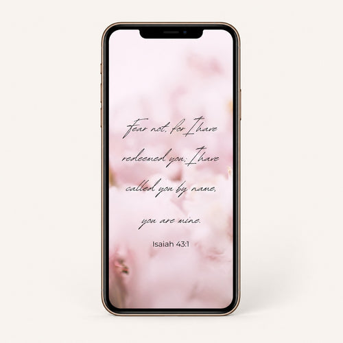 Smartphone with a floral background and Bible scripture 'Isaiah 43:1' quote on a white background