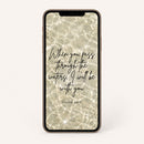 Phone screen displaying a Bible scripture quote of Isaiah 43:2 with a water background