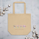 Beige tote bag on a light gray background with cotton branches