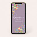 Smartphone with floral design and 'Known by the Shepherd' text on a light gray background