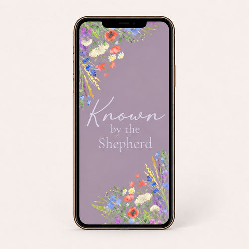 Smartphone with floral design and 'Known by the Shepherd' text on a light gray background